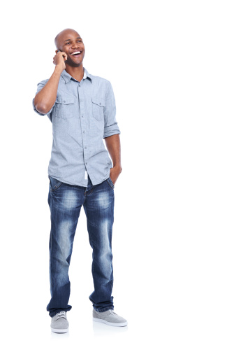 A smiling african american man using his smartphone while isolated on white