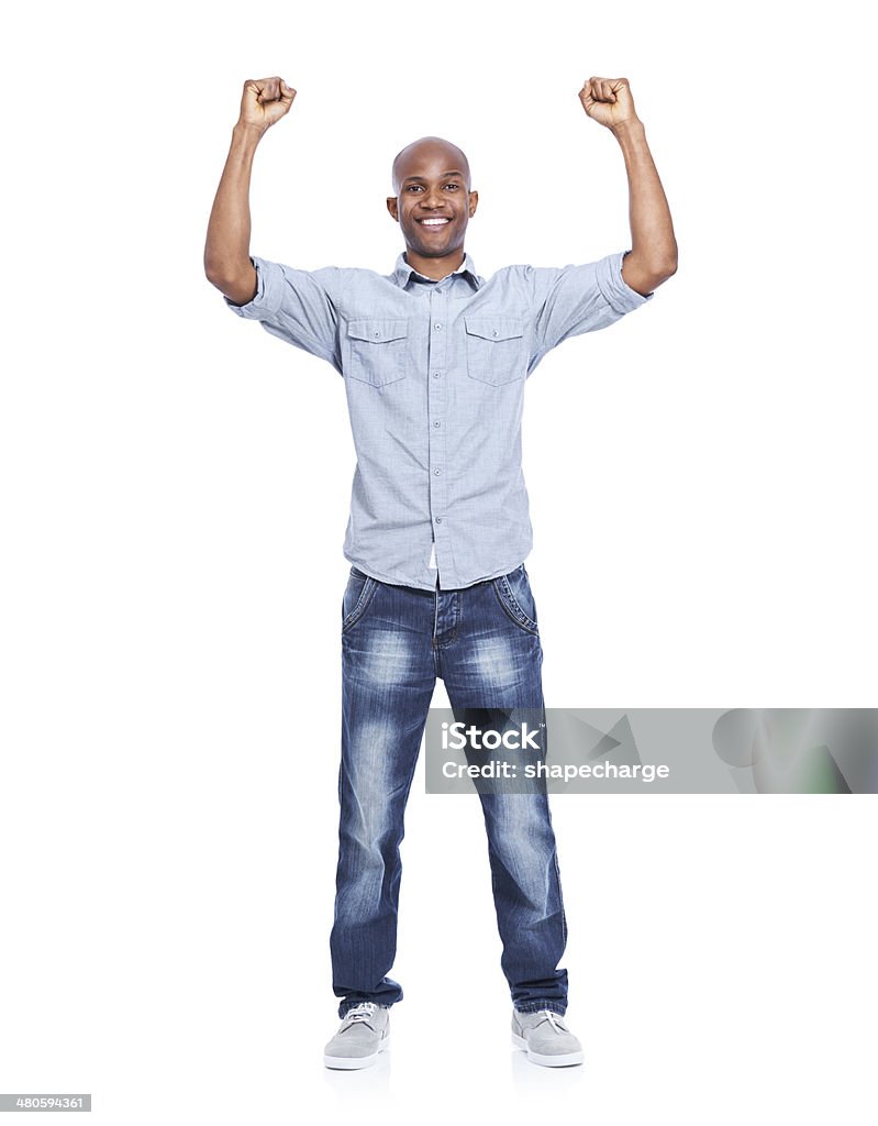 Alright, I won! A smiling african american man celebrating and cheering while isolated on white Men Stock Photo