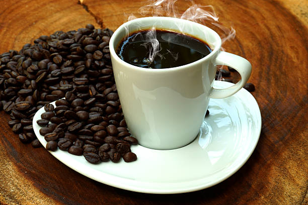 istock Coffee cup and beans on a wood background. 480598887