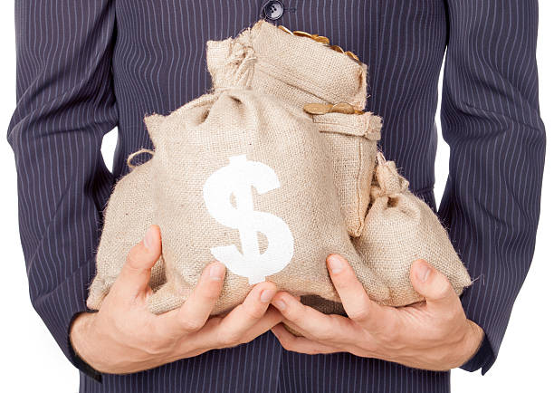 istock hands holding bags with coins 480598906
