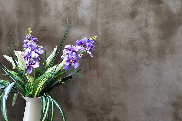 istock Bouquet of peonies in a vase against  wall. Interior 480599231