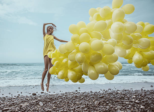 istock girl with yellow balloons 480600027