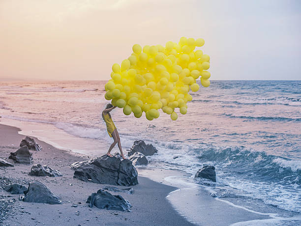 istock girl with yellow balloons 480600041