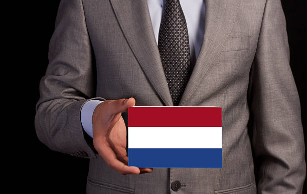 istock Businessman Holding a Card with NETHERLANDS Flag 480600395