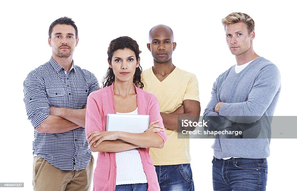 Success sometimes needs a serious approach An attractive woman holding a digital tablet while three male coworkers standing behind her Copy Space Stock Photo