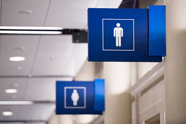 Mens Restroom Sign A vivid blue mens restroom sign with the female sign in the background. toilet sign stock pictures, royalty-free photos & images