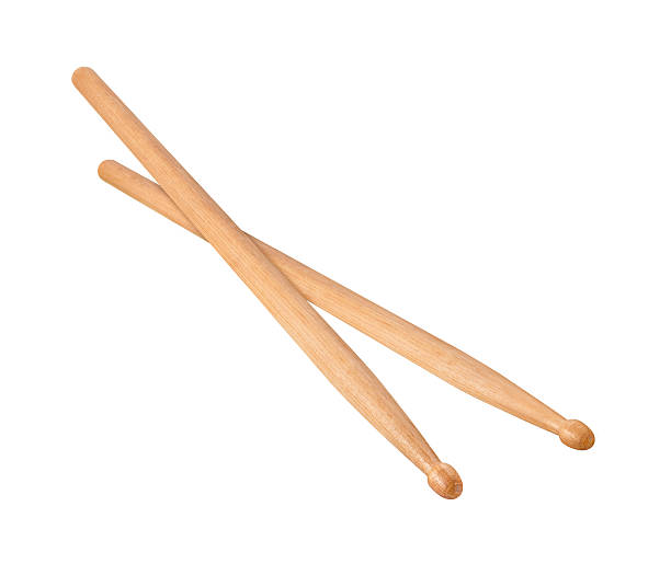 Two Wooden Drumsticks isolated Two Wooden Drumsticks, one on top of the other. The lighting is soft. The woodgrain is clearly visible. The drumstick is a long cylindrical stick, made from wood, and tappers on the end to a bulbous tip. The image is shown at an angle, and is in full focus from front to back. The image is a cut out, isolated on a white background, and includes a clipping path. drumsticks on white stock pictures, royalty-free photos & images
