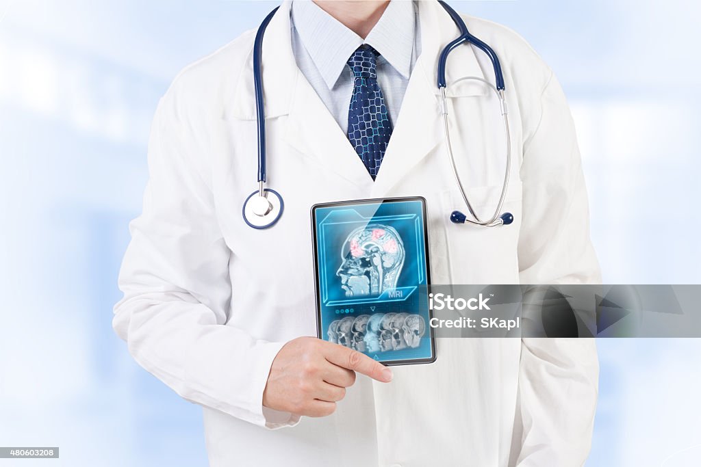 Brain scan Doctor with fMRI scan on tablet screen Neuroscience Stock Photo