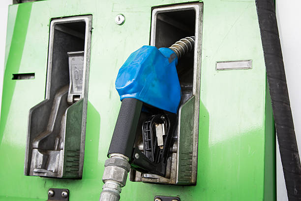 bocais da bomba de combustível em posto de gasolina - gas fuel pump labeling fuel and power generation - fotografias e filmes do acervo
