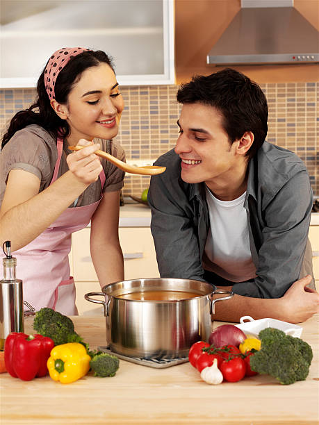 istock Young couple tasting soup in kitchen 480606807