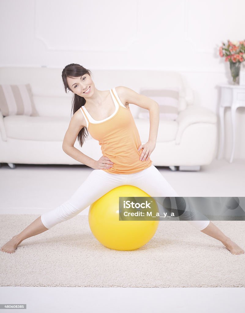 Exercise at home Healthy young woman stretching at home Activity Stock Photo