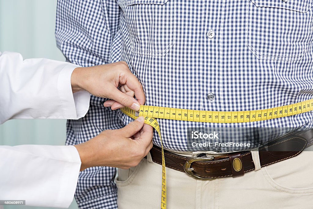 Overweight Medical examination: doctor measures overweight Overweight Stock Photo