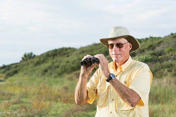 istock Man on safari, with pair of binoculars 480609233