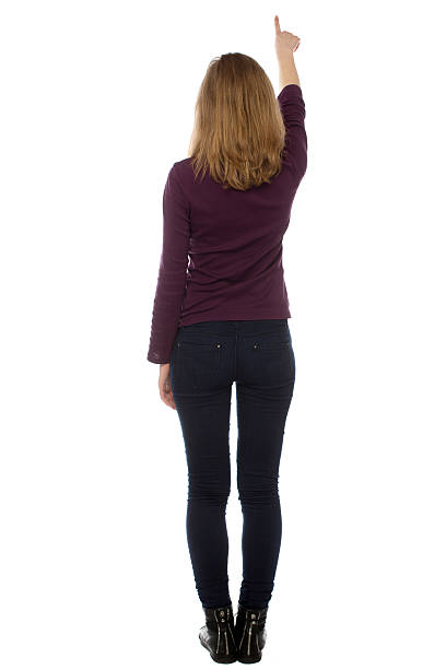 istock Woman standing writing or pointing upwards 480609481