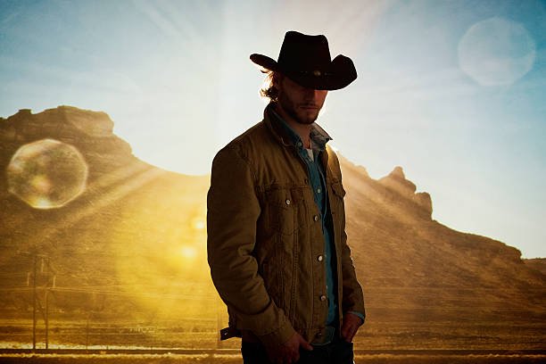 istock Cowboy standing in front of hill 480609498