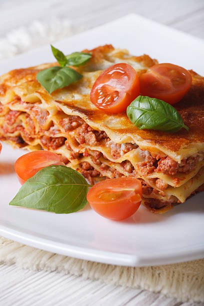 istock Portion of Italian lasagna on a white plate. Vertical 480609870