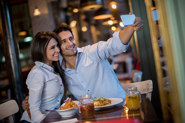 istock Loving couple taking a selfie at a restaurant 480609904