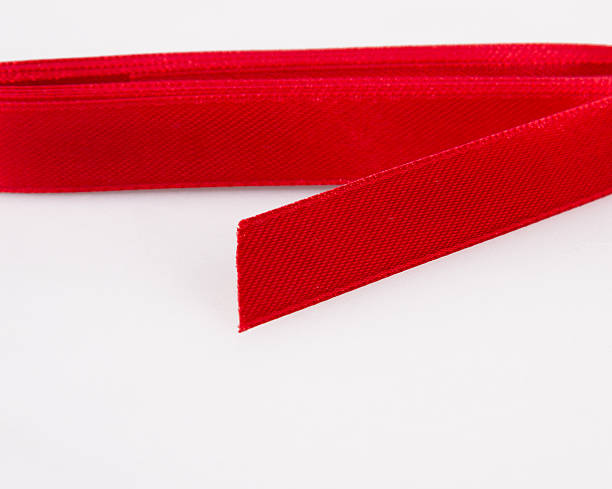 istock Shiny red ribbon on white background 480610778
