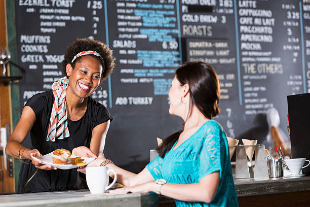 istock Woman working in coffee shop, serving customer 480610879