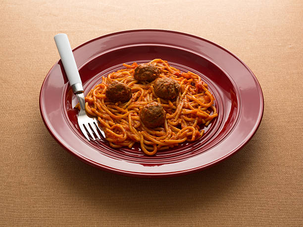 istock Spaghetti and meatballs on a red dish with fork. 480610972