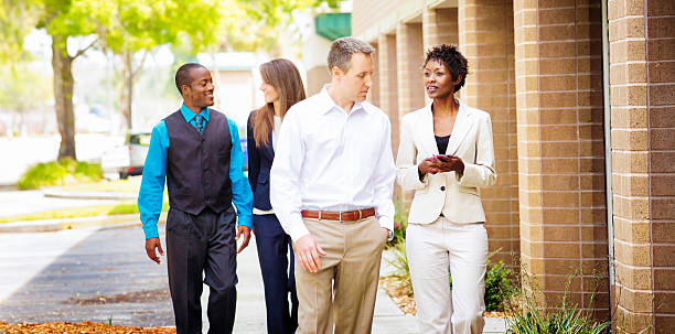 istock Multi-racial four people business team walking to work 480611158