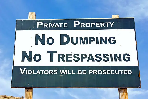 Sign with no dumping and no trespassing on it.