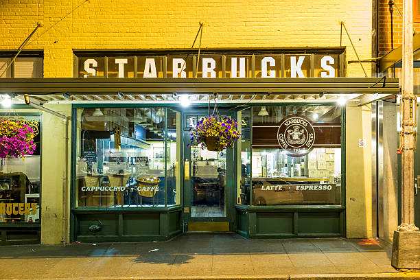 Original Starbucks store at 1912 Pike Place SEATTLE , USA - July 5, 2014: Original Starbucks store at 1912 Pike Place on July 5, 2014 in Seattle. Serving coffe in 20.891 stores in 62 countries, Starbucks is world's largest coffeehouse company. pike place market stock pictures, royalty-free photos & images