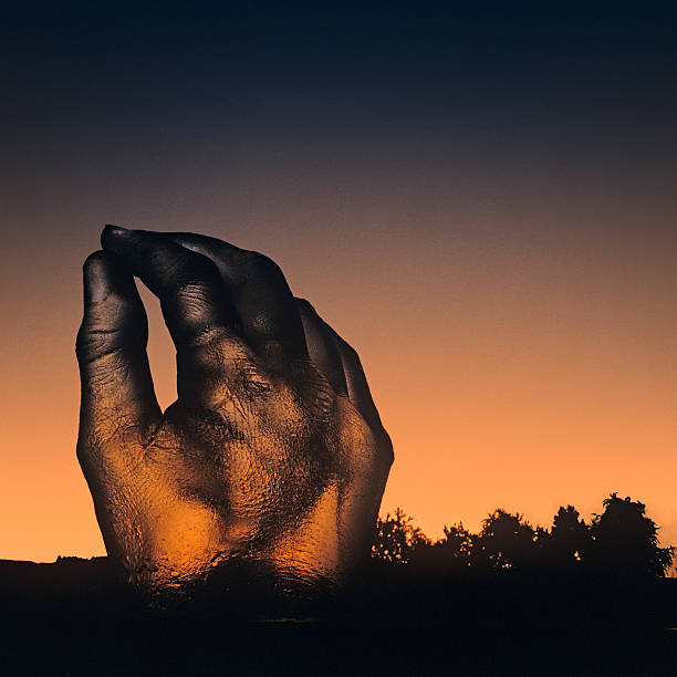 Photo composition with a hand out of artificial resin