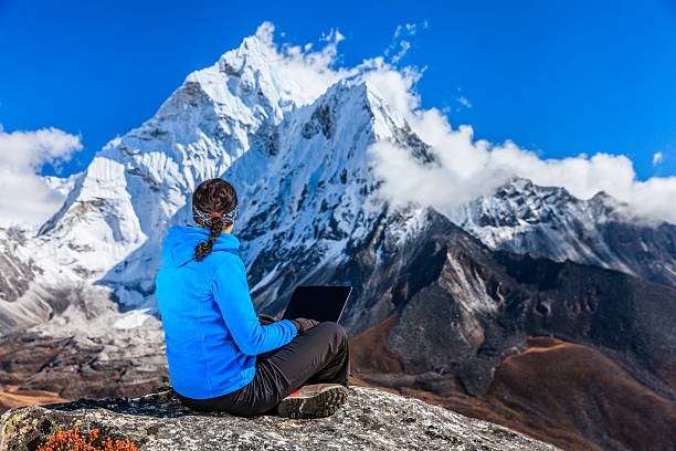 istock Woman is using laptop in Mount Everest National Park, Nepal 480612521