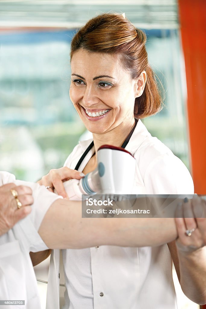 Senior woman receiving home therapy Physical Therapy Stock Photo