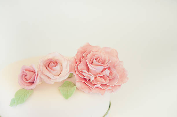 Beautiful pink floral cake decoration made of icing.
