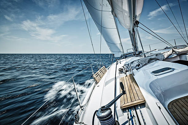 Sailing with sailboat Sailing with sailboat. Long exposure. yachting stock pictures, royalty-free photos & images