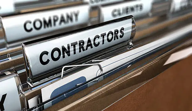 Close up on a file tab with the word contractors, focus on the main word and blur effect. Concept image for illustration of contractors or subcontractors company database.