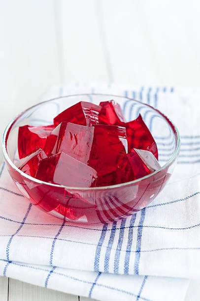 istock Red jelly cubes in glass bowl on dish towel 480615766
