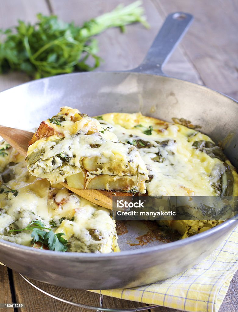 Spinach and potato fritata Spinach and potato fritata in a  frying pan Baking Stock Photo