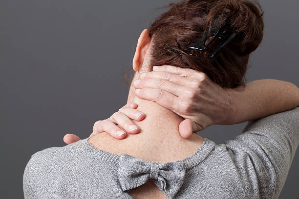 self-acupressure for relaxing shoulder and backache neck and shoulder gestures for releasing tension in back cervical vertebrae photos stock pictures, royalty-free photos & images