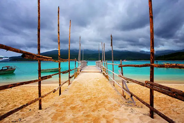 Photo of Old wooden jetty on a beautiful tropical beach