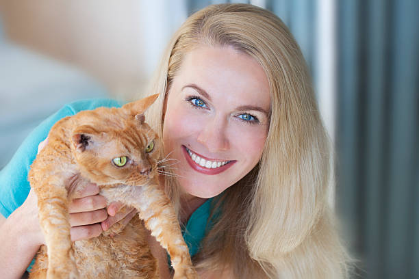istock Pretty woman holding a ginger cat 480620351