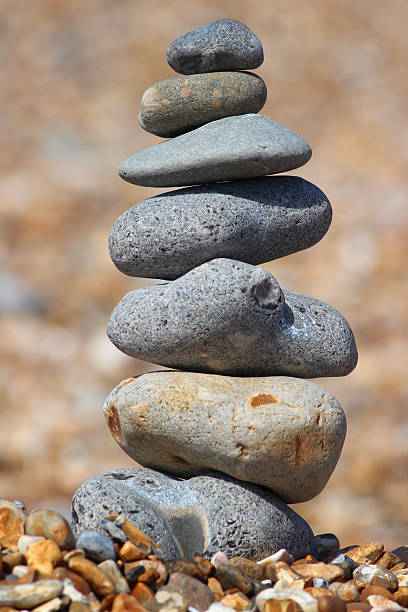 istock Image of towering stack of pebbles on beach, balancing stone-tower 480620518