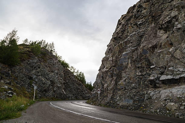 istock twist road in mountain pass to traffic signs 480620528