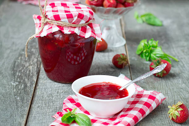 istock Confiture with strawberries and basil on a wooden background 480620926