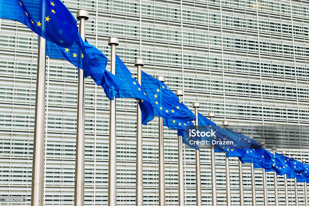 EU flags near EU headquarters Berlaymont European Commission bui Blue EU flags with its stars in Brussels in front of European Commission and Parliament - Berlaymont, executive government of European Union Brussels-Capital Region Stock Photo