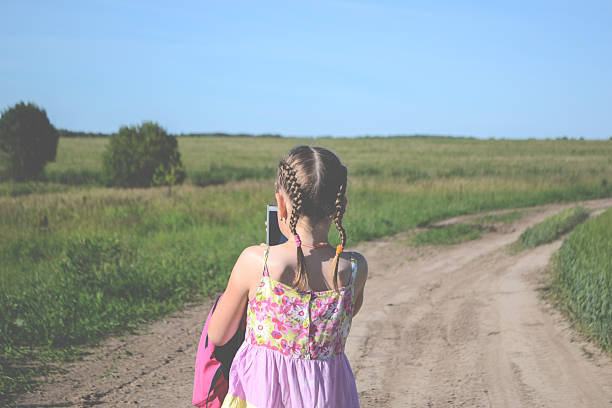 istock Little girl walking with gadget 480624632