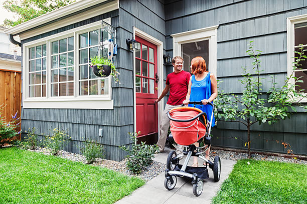 Young Family Leaving Home with Baby Stroller
