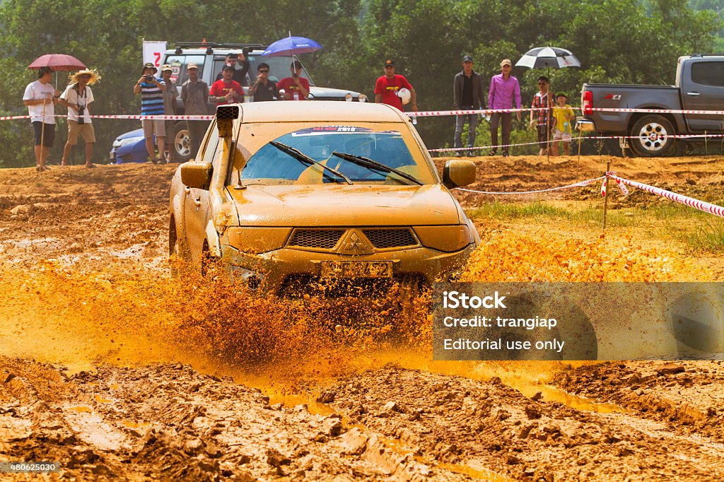 Mitsubishi Triton car Hanoi, Vietnam - July 4, 2015: Mitsubishi Triton pick-up car doing an circuit of Vietnam Off-road Cup (VOC) in a water road area of Hanoi 2015 Stock Photo