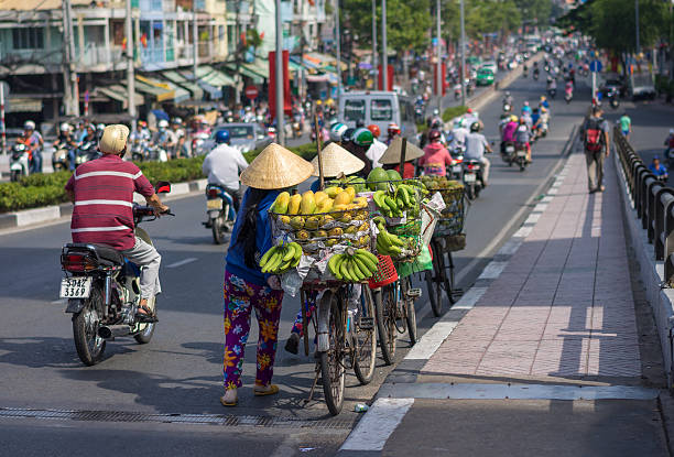 типичная улица фрукты поставщика с в виде пальмовых листьев conical hat - palmleaf стоковые фото и изображения