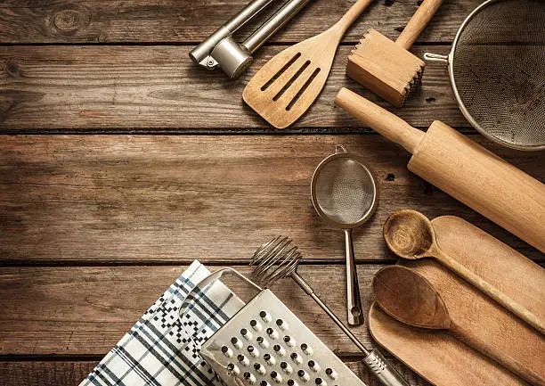 Photo of Rural kitchen utensils on vintage planked wood table