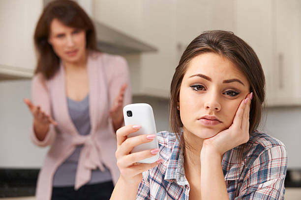 mãe com a filha discutir sobre o uso de telefone celular - mom yelling on phone - fotografias e filmes do acervo