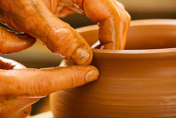 istock hands of a potter, creating an earthen jar 480628197