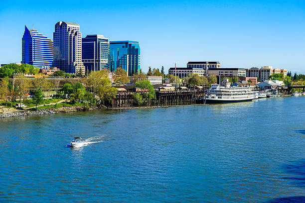 Sacramento River, riverfront and downtown skyline Sacramento skyline and riverfront on the Sacramento River. riverbank photos stock pictures, royalty-free photos & images